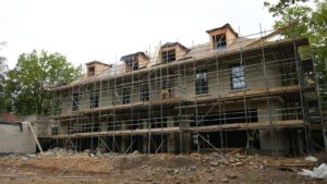 Woodrising luxury home under construction with scaffolding
